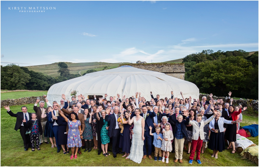 A wedding party in front of a yurt.