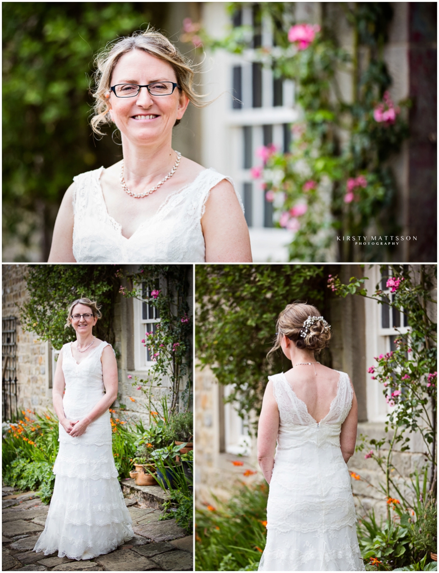A bride in a wedding dress standing in front of a flower garden.