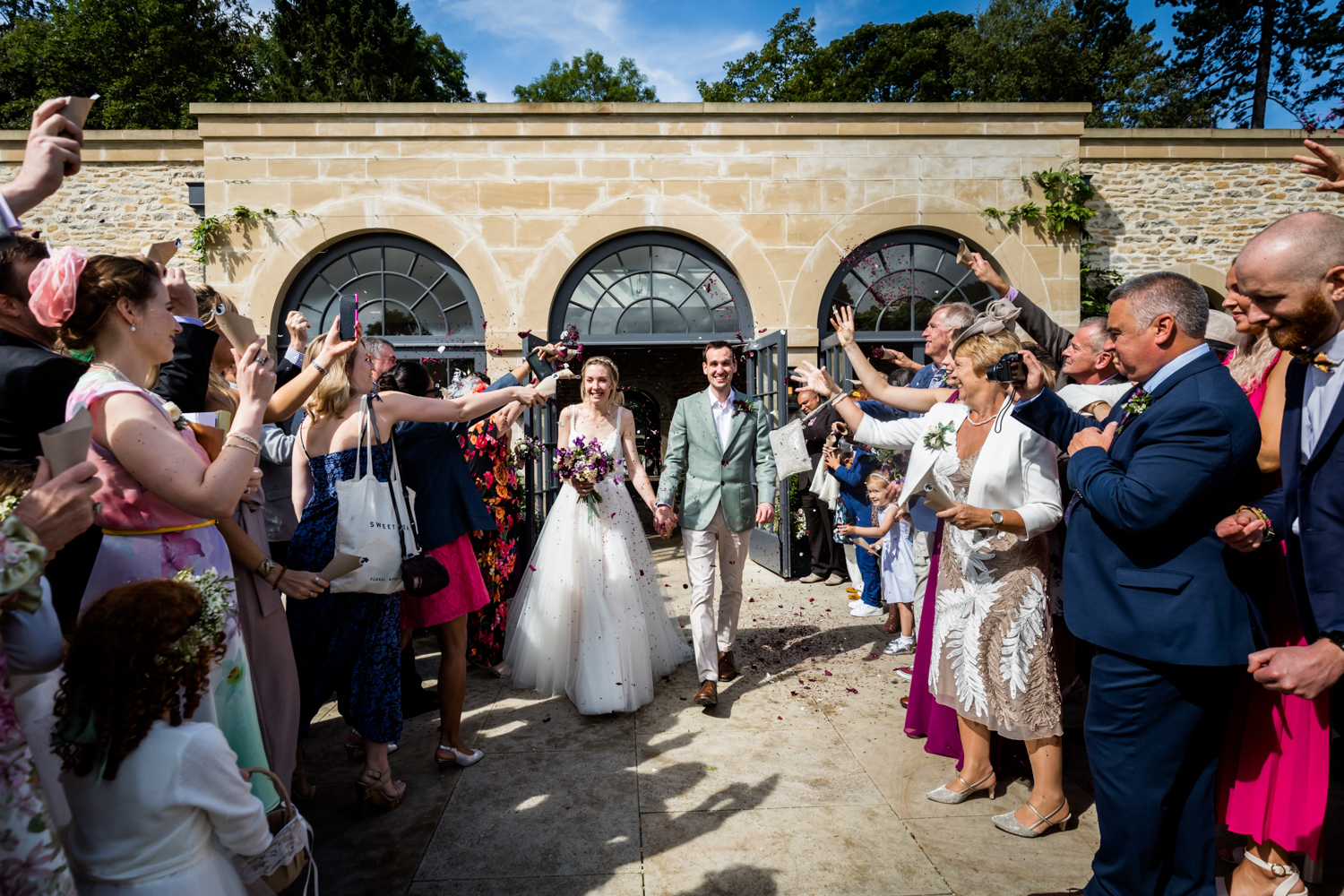 Middleton Lodge Wedding Photography - couple showered with confetti