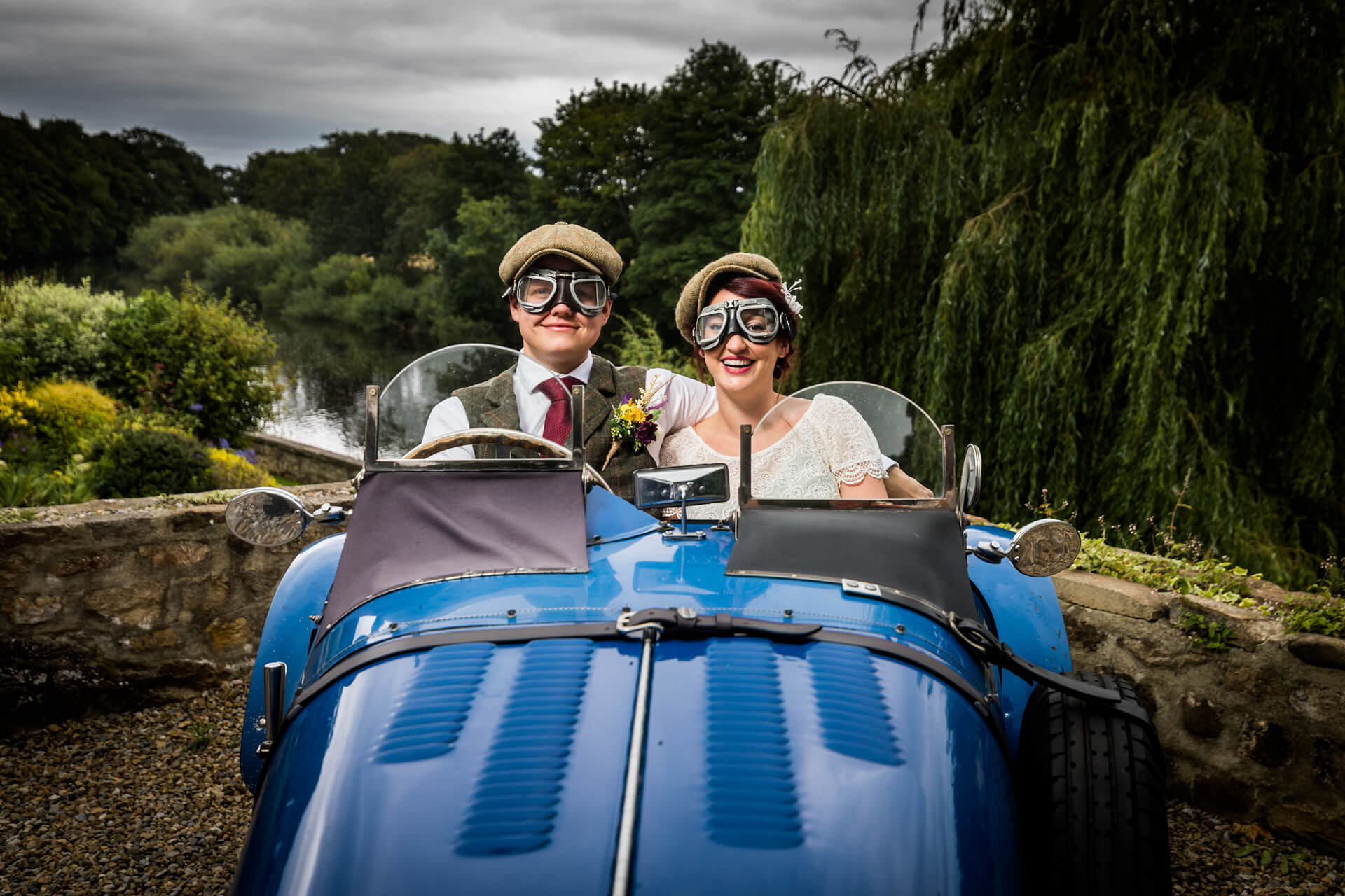 bride and groom sitting in a classic car