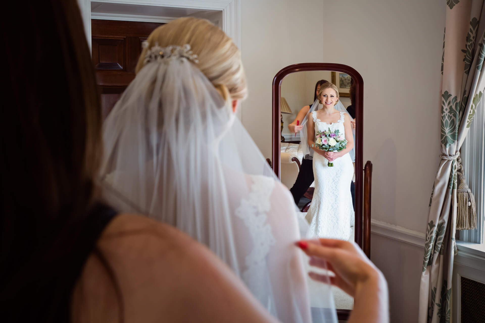 Bride having her veil attached at Denton Hall