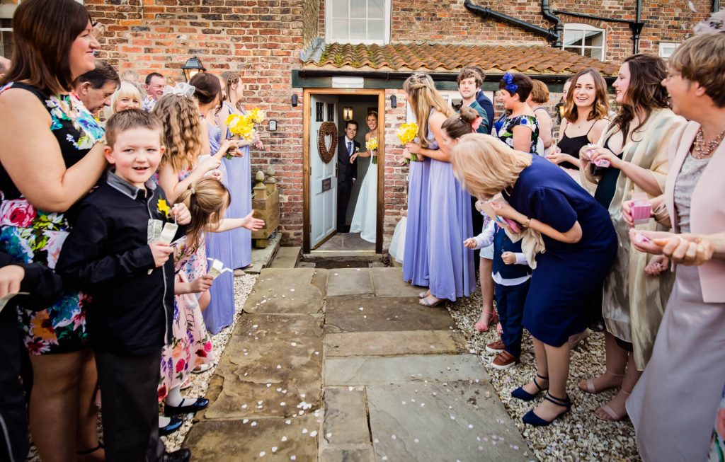 couple about to walk the confetti line at Hornington Manor