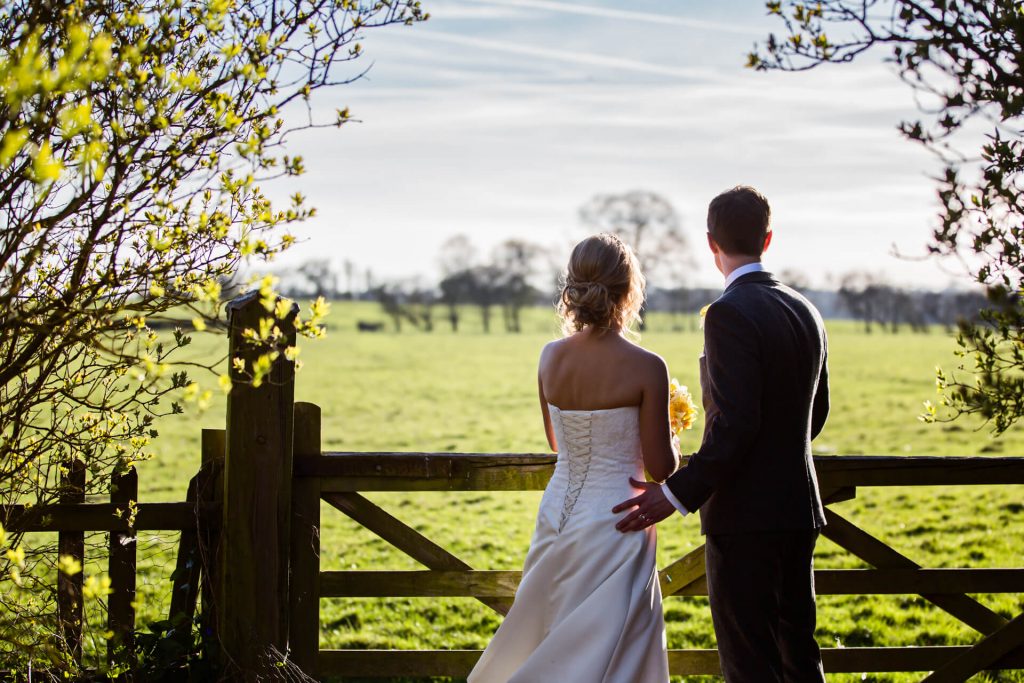 Wedding couple looking at the sunset at Hornington Manor