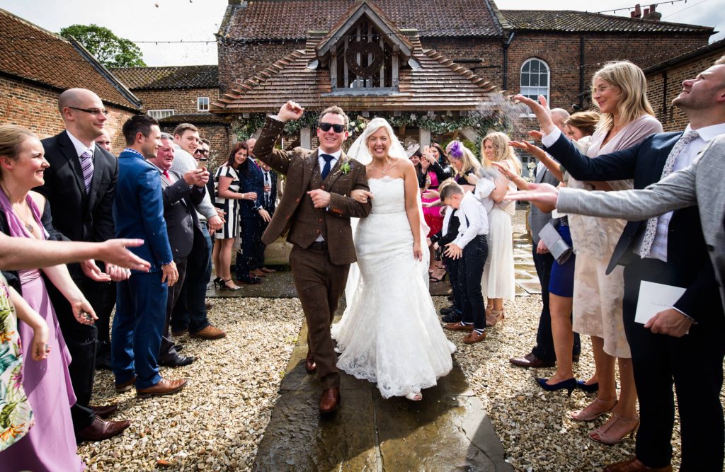 couple under the confetti at Hornington Manor