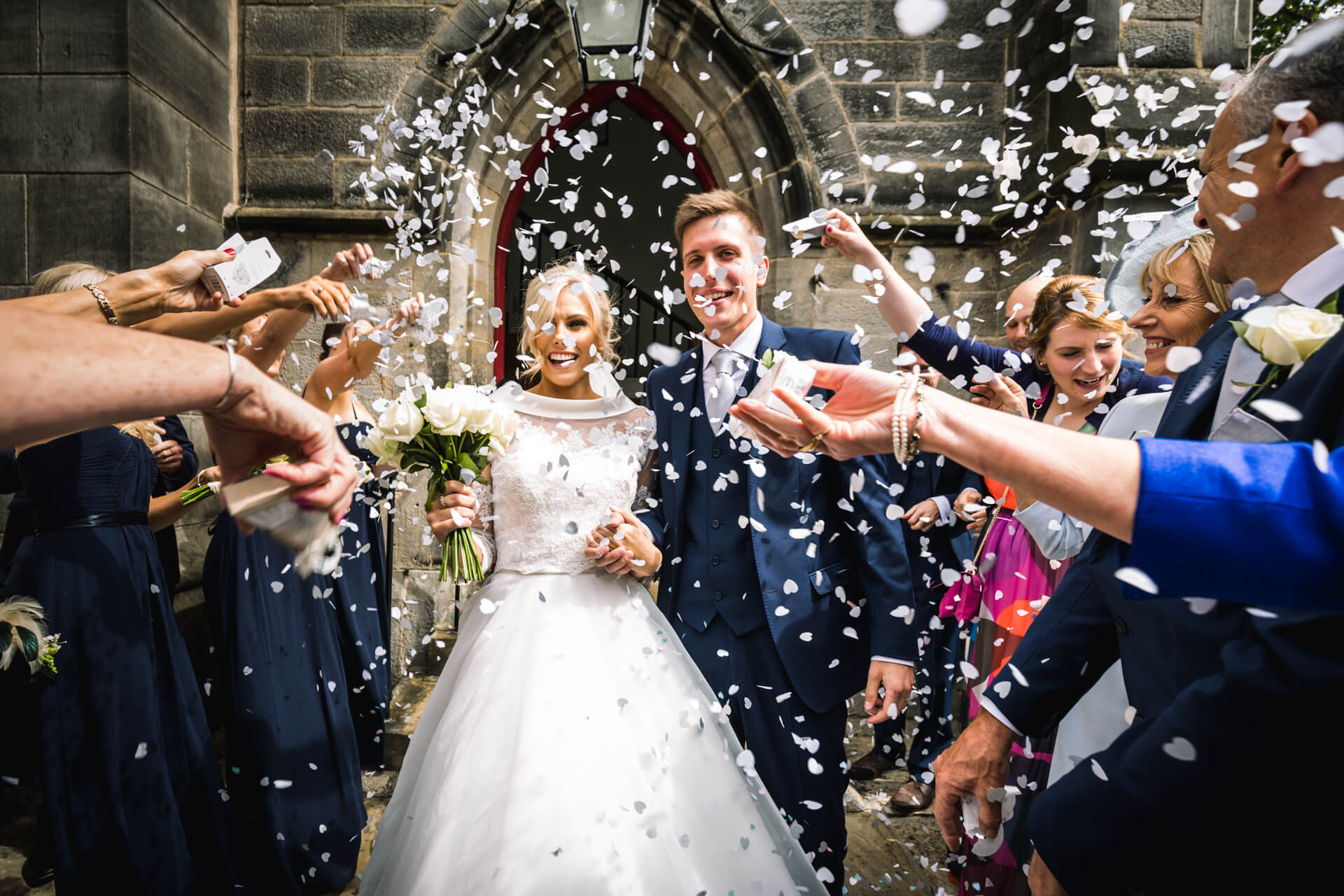 Bride and groom showered with confetti