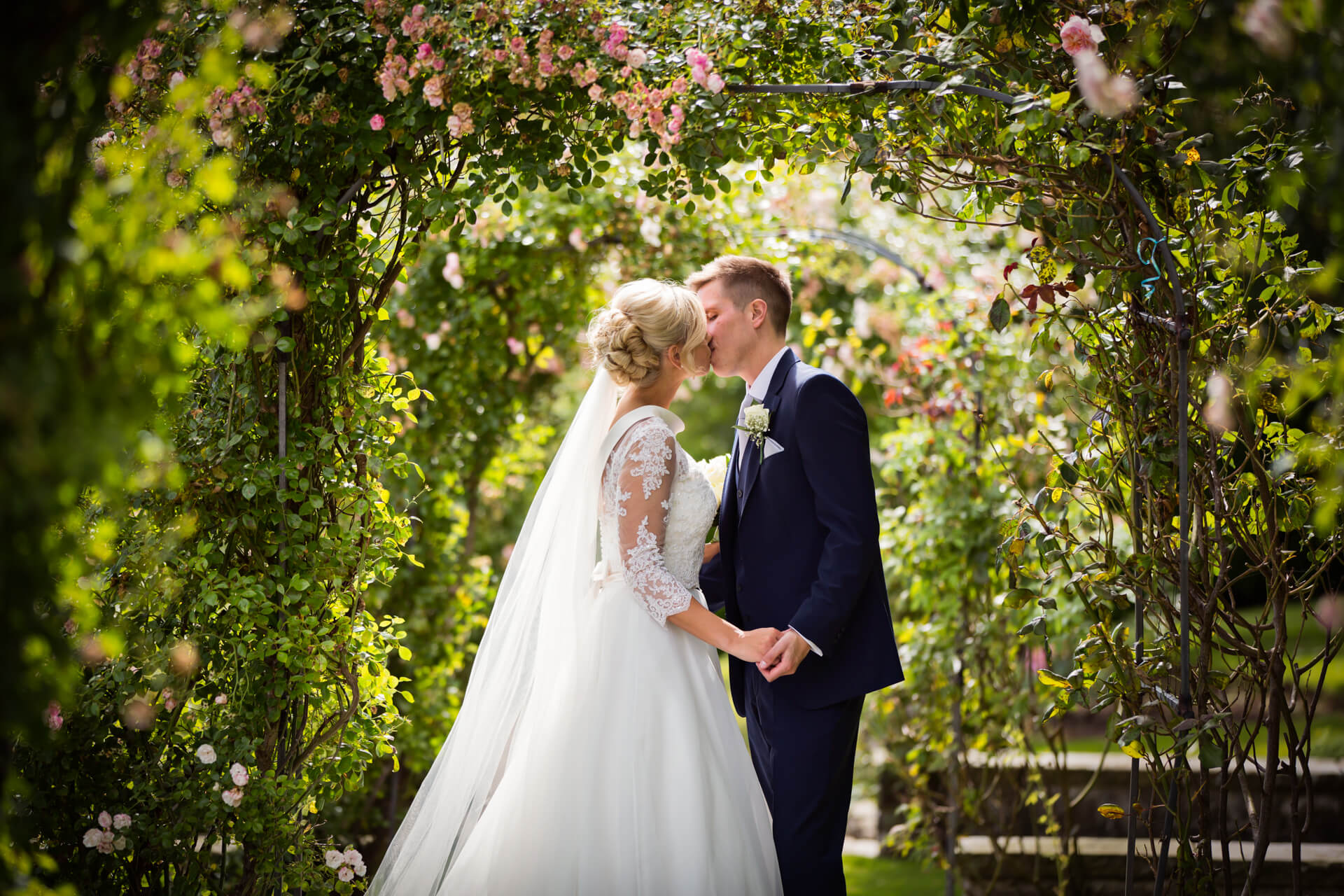 Wood Hall Hotel Wedding Photography - couple kissing under the blossoms