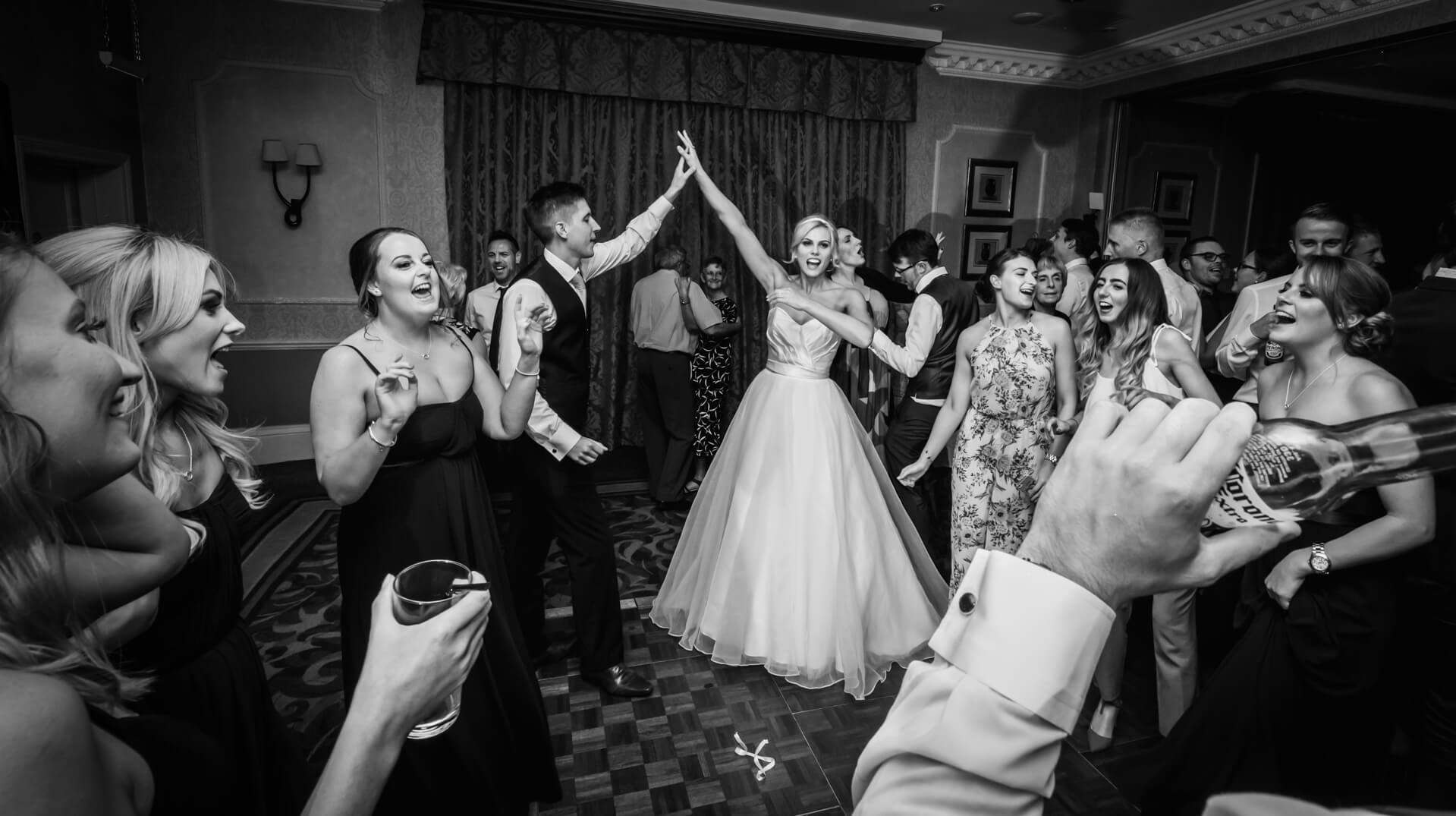 Wood Hall Hotel Wedding Photography - bride and groom dancing with guests