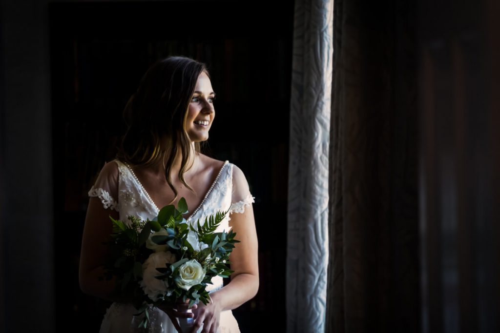 Saltmarshe Hall - portrait of the bride in the window