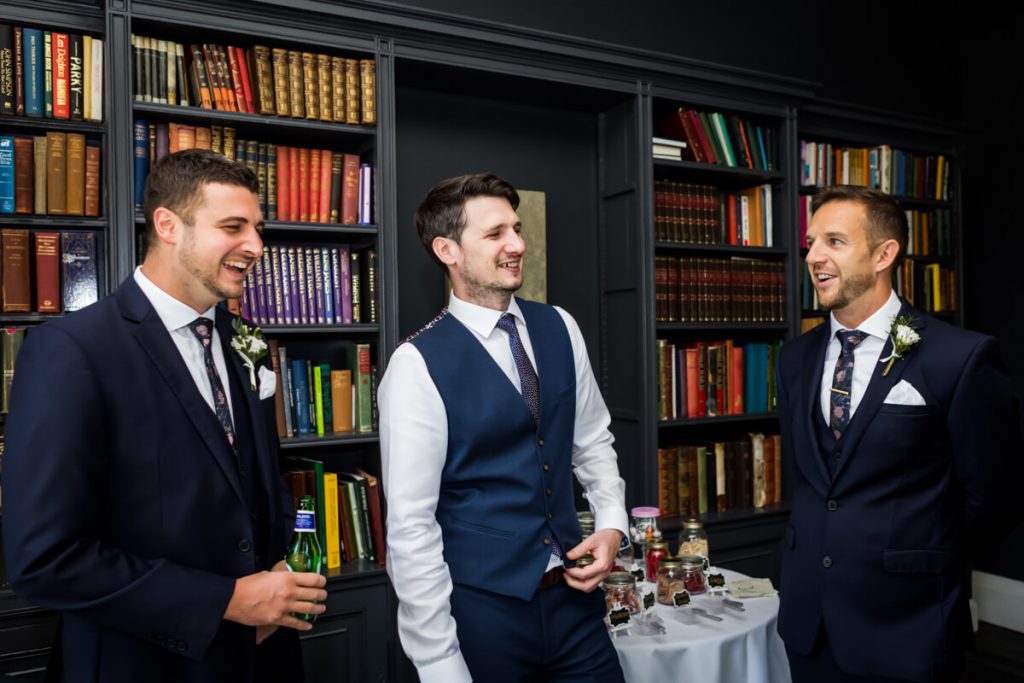 groom and his groomsmen in the library at Saltmarshe Hall