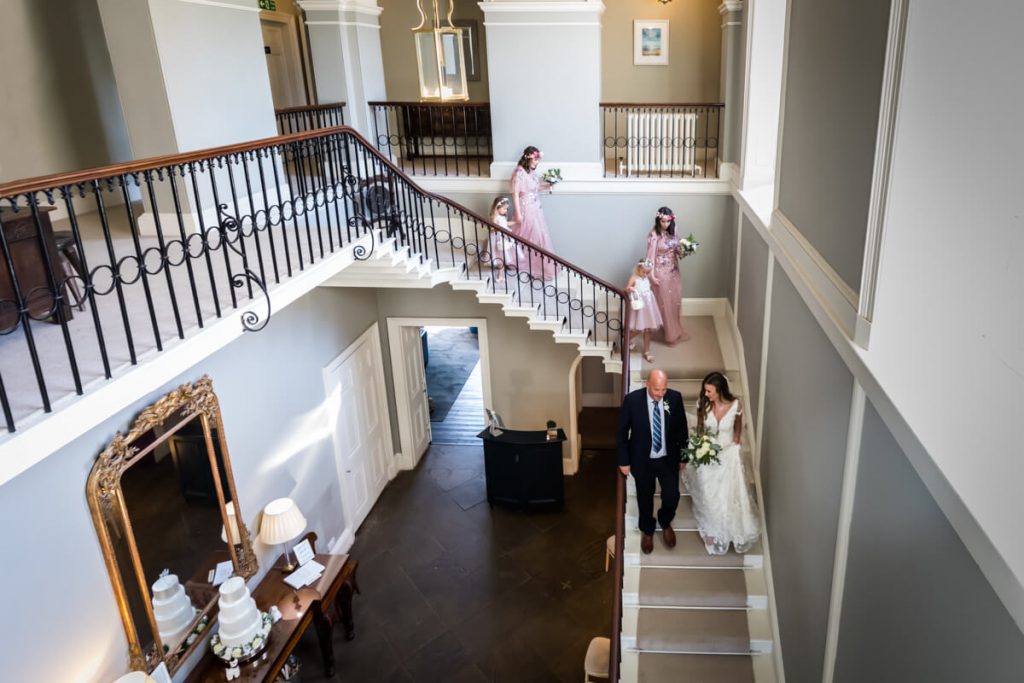 bridal party descending the stairs at Saltmarshe Hall