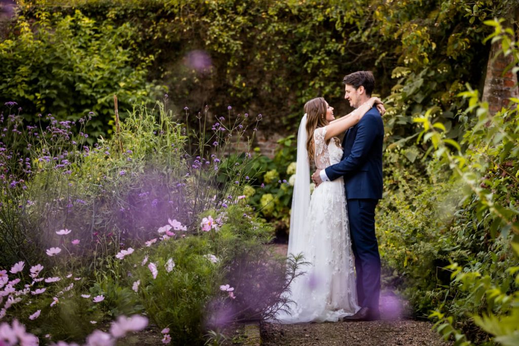 Saltmarshe Hall wedding photography- bride and groom embracing in the gardens