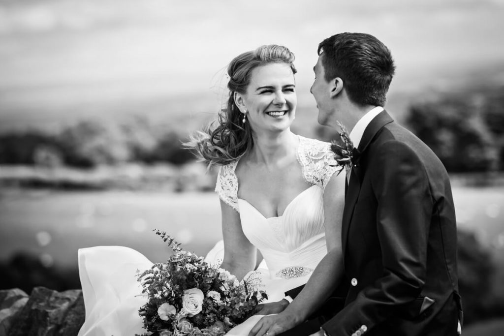 bride and groom sitting together and laughing