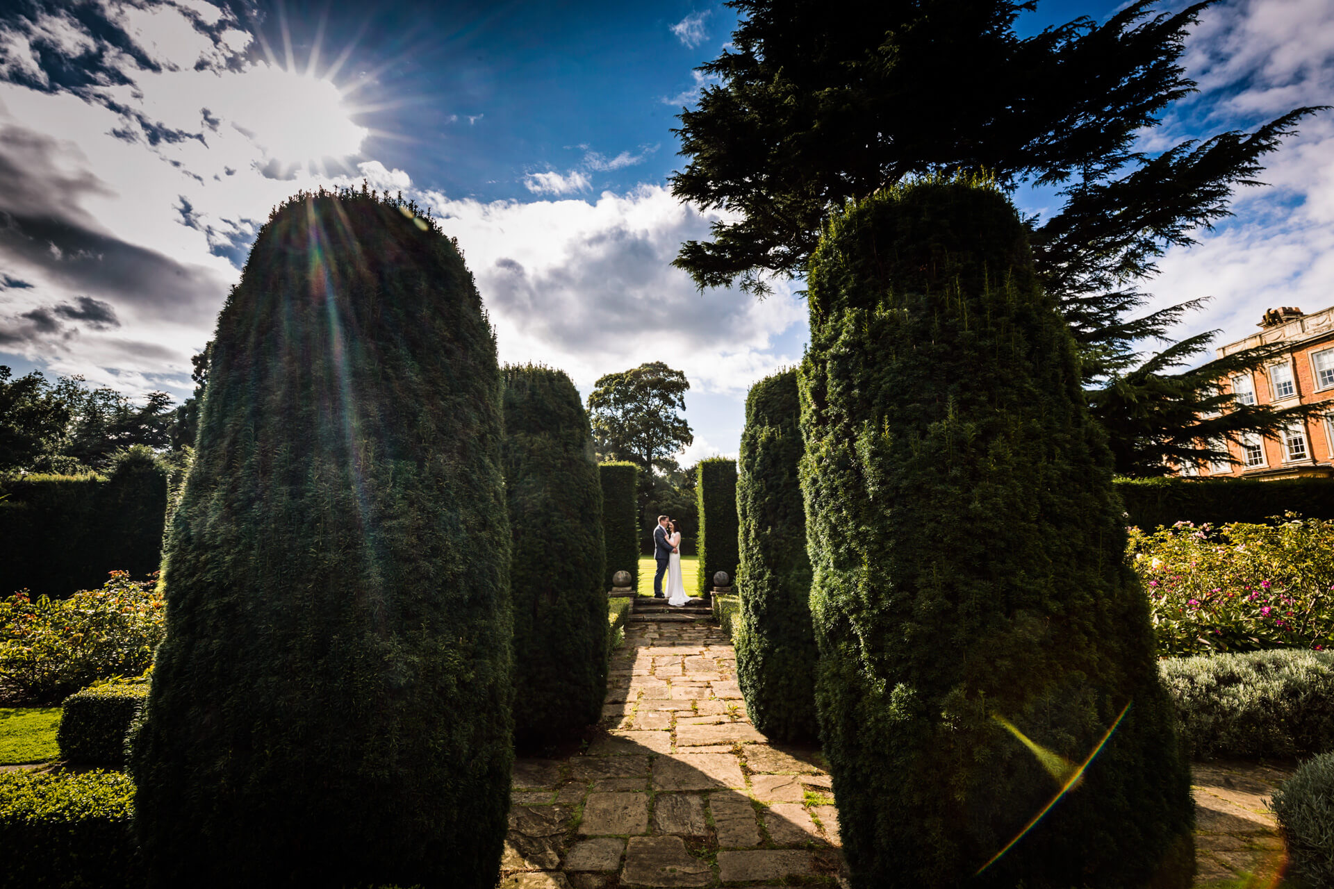 bride and groom hugging in the gardens of Middlethorpe hall