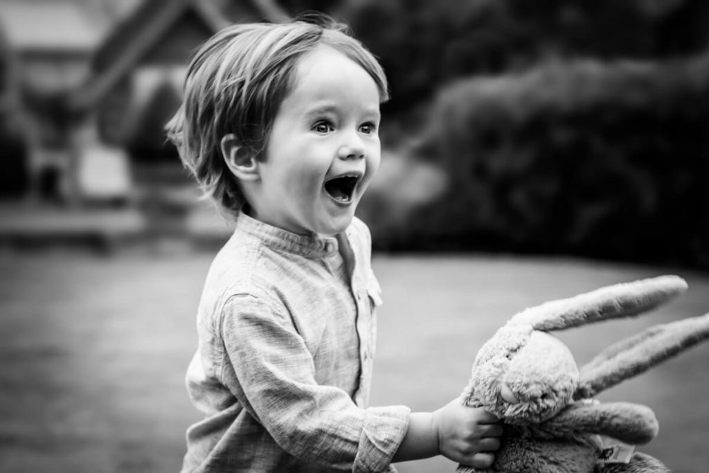 toddle running fast with his teddy bear