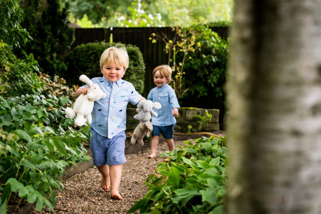 two toddlers running in a leeds family garden