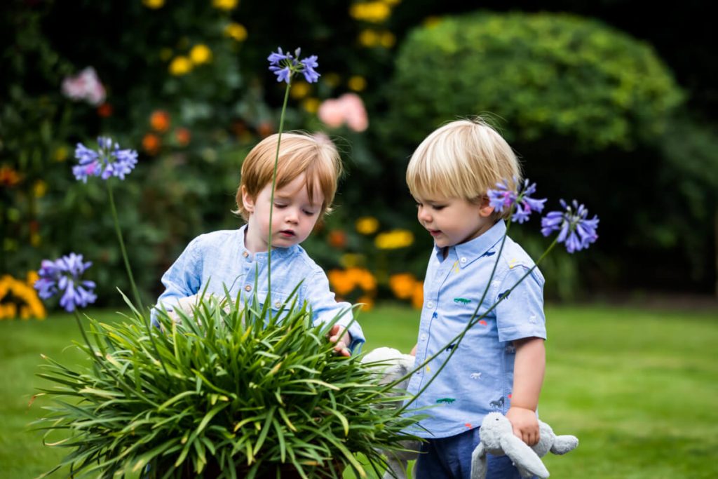 two little boys looking at some flowers