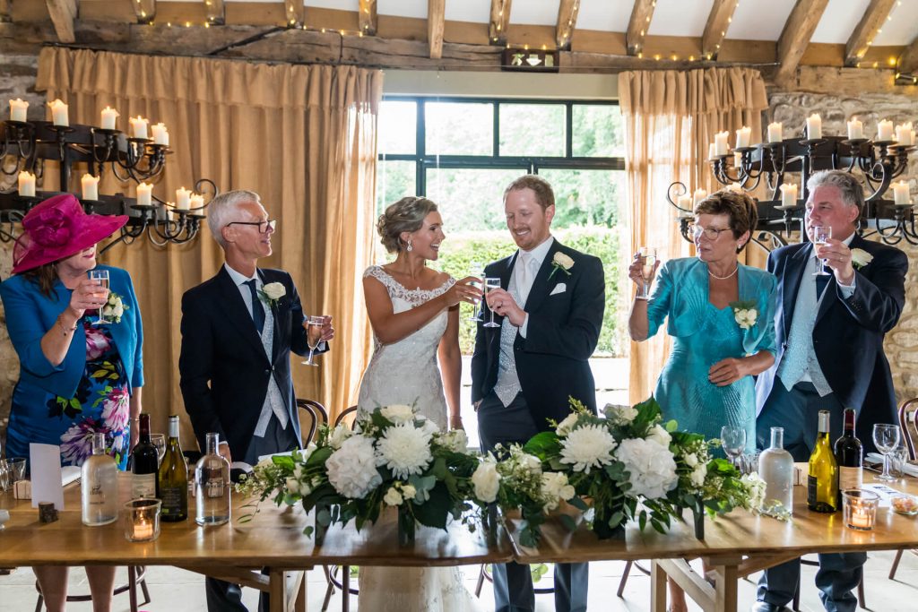 bride and groom toasting during the speeches