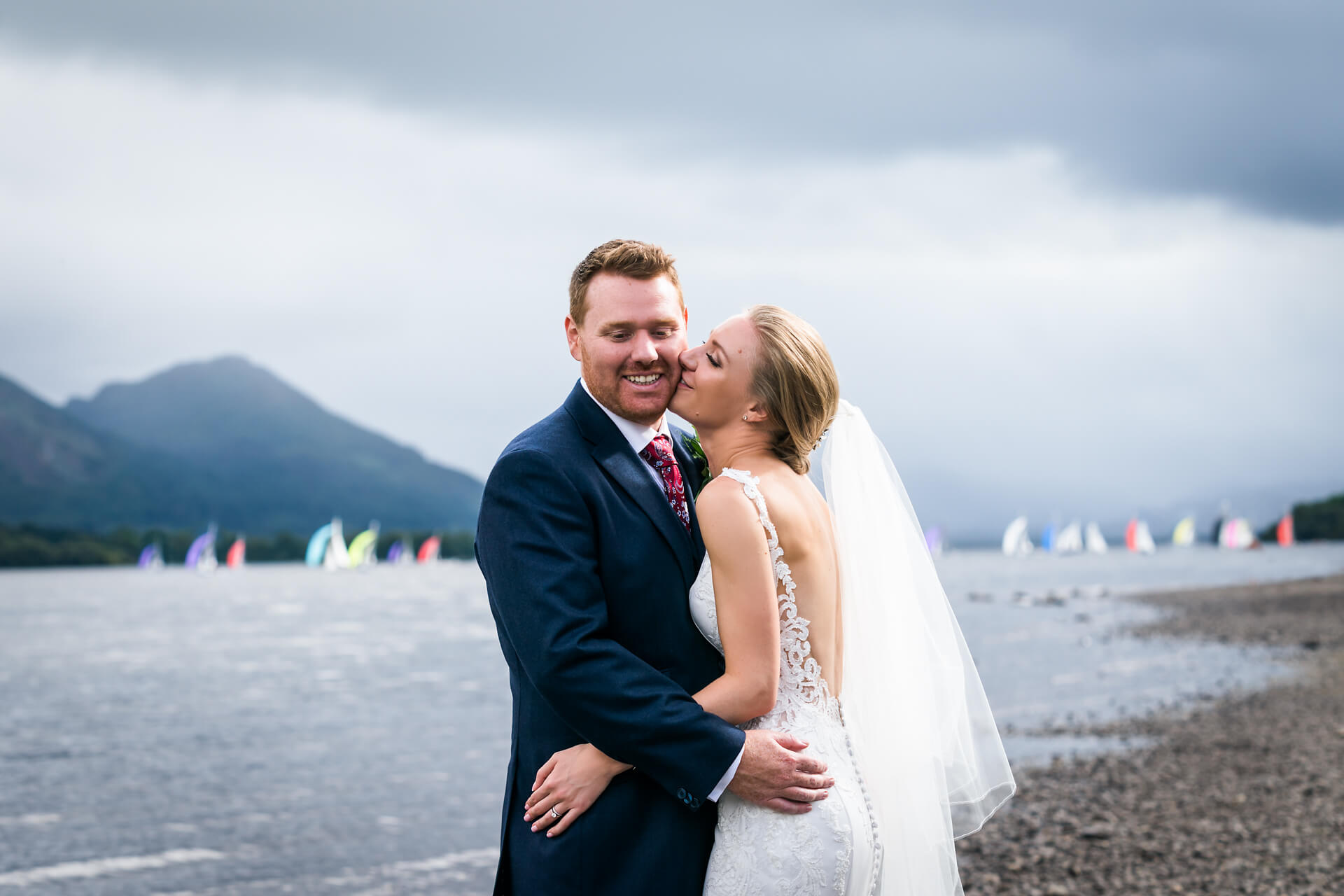 bride and groom by a lake in the Lake District