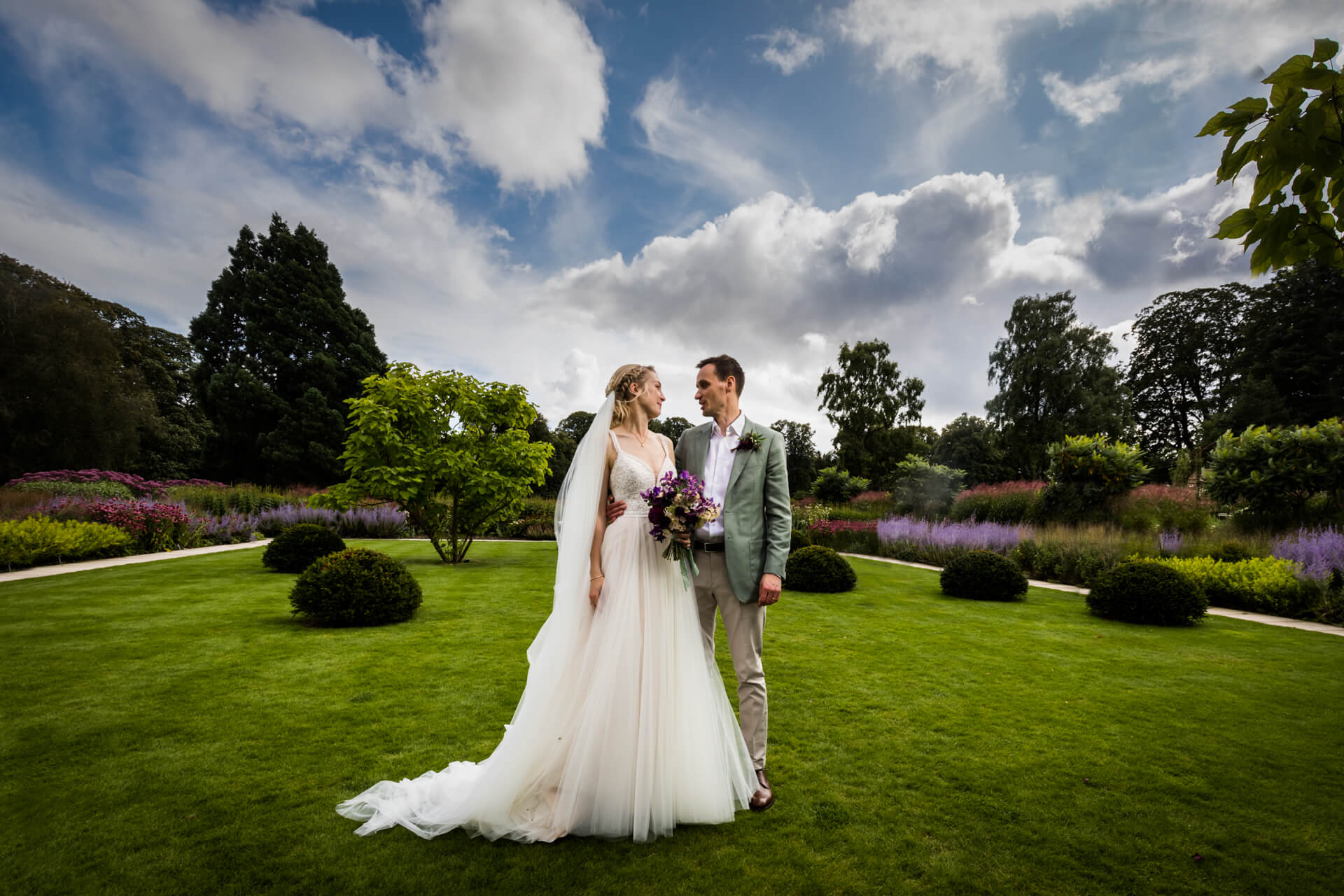 bride and groom chatting in the gardens of Middleton Lodge