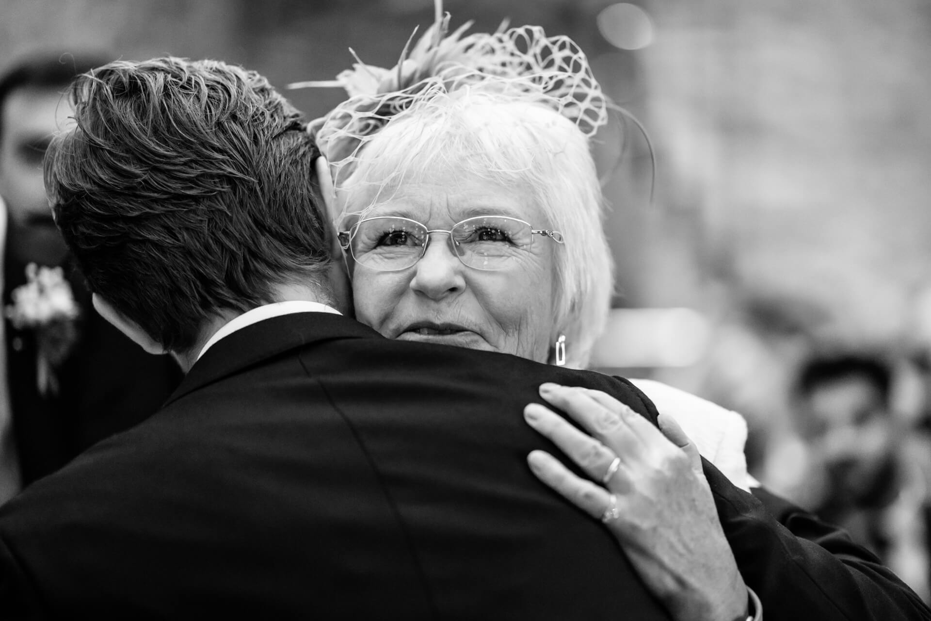 mother of the bride hugging the groom