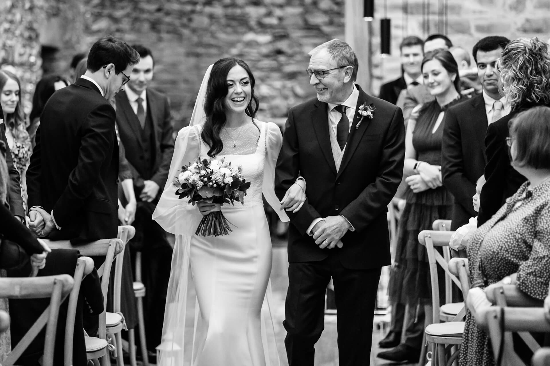 bride and father walking the wedding aisle