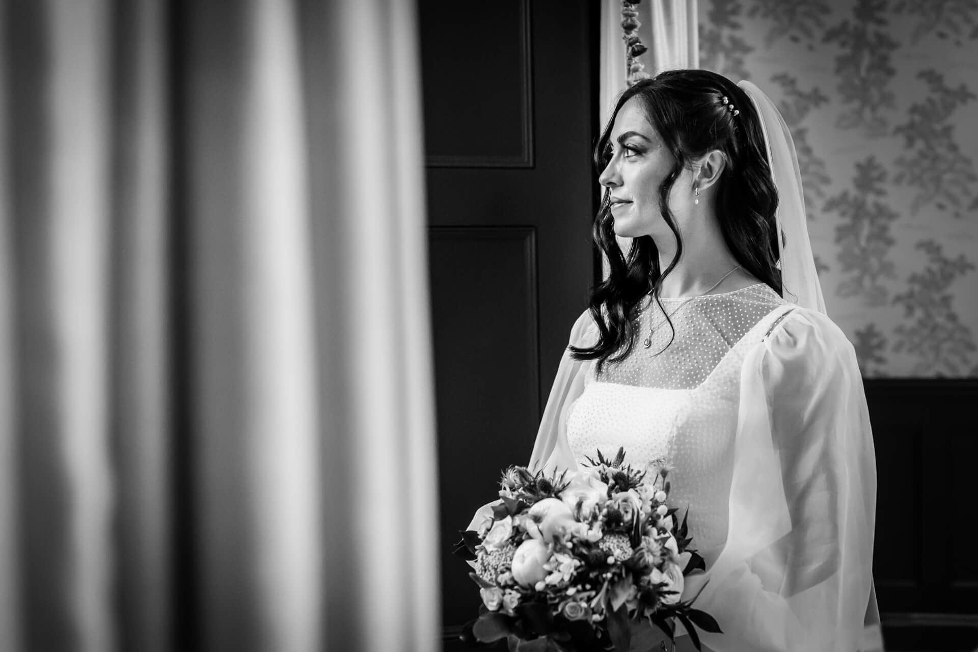 bride looking out the window at the town head estate