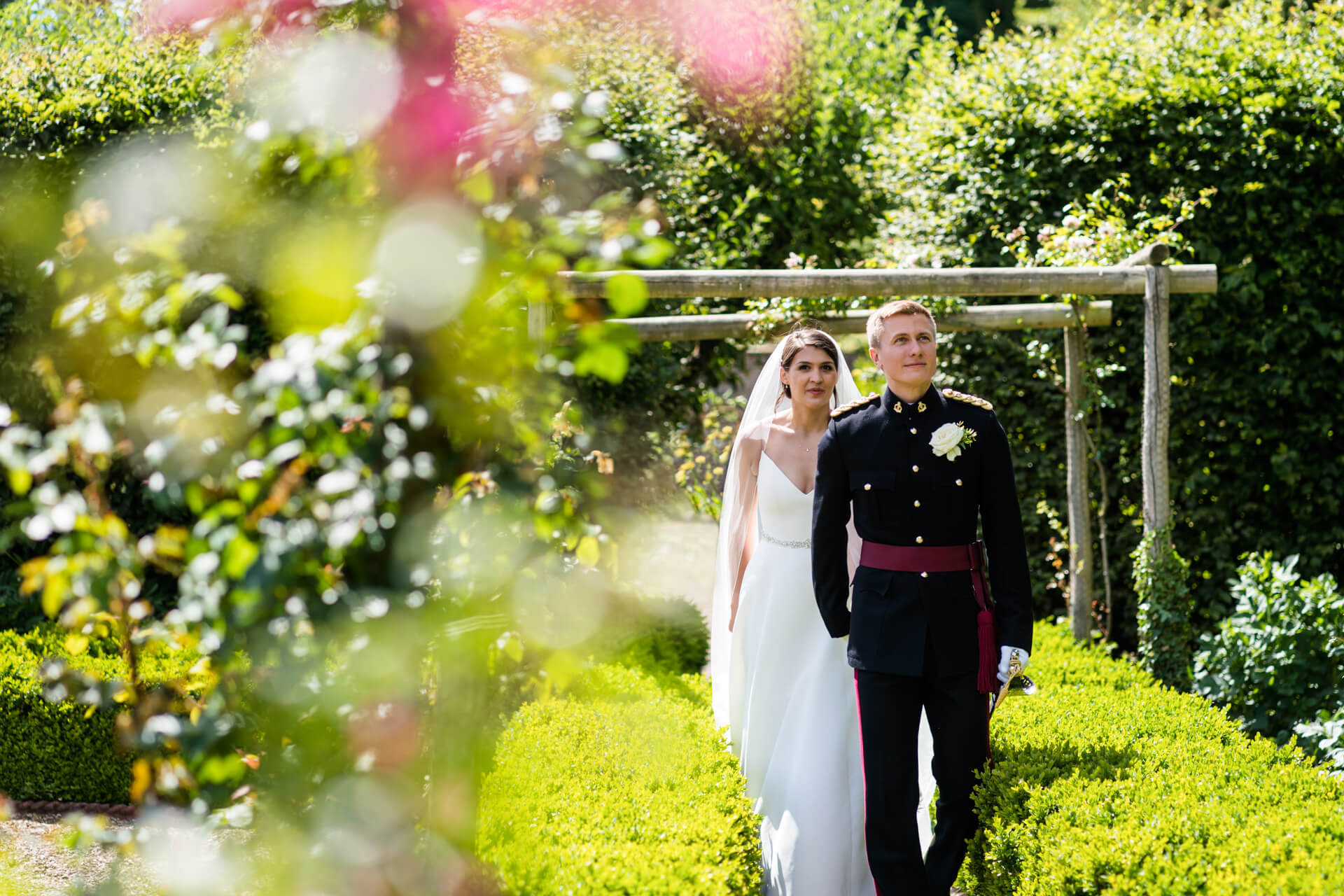 bride and groom walking through the gardens at Ripley Castle