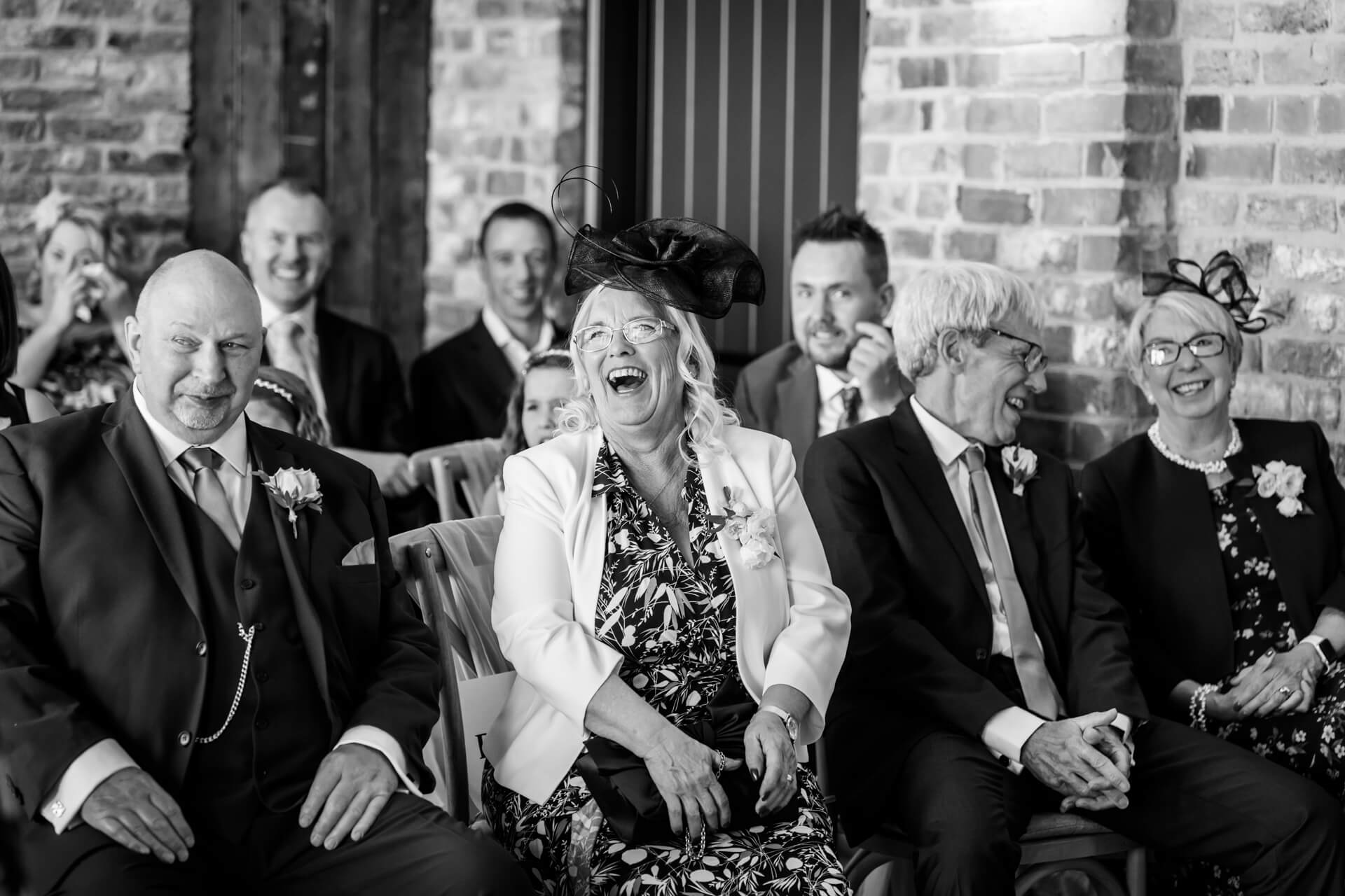 wedding guests laughing during the ceremony