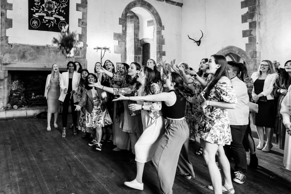 wedding guests capturing the bouquet