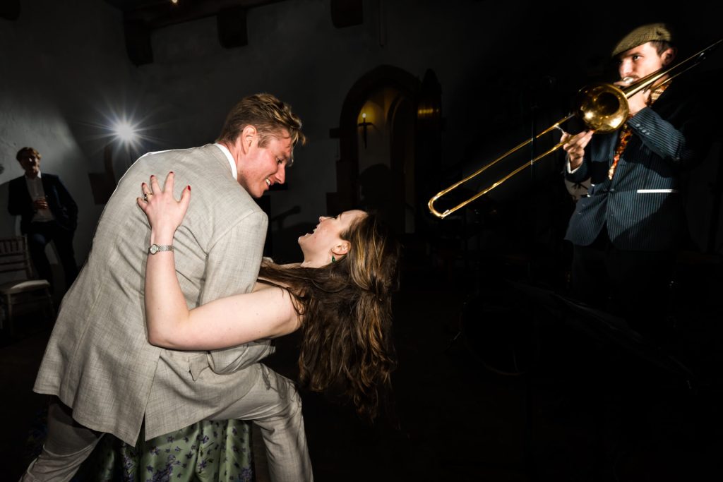the groom dips the bride during their first dance at Bolton Castle