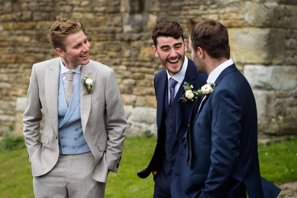 groom laughing with groomsmen