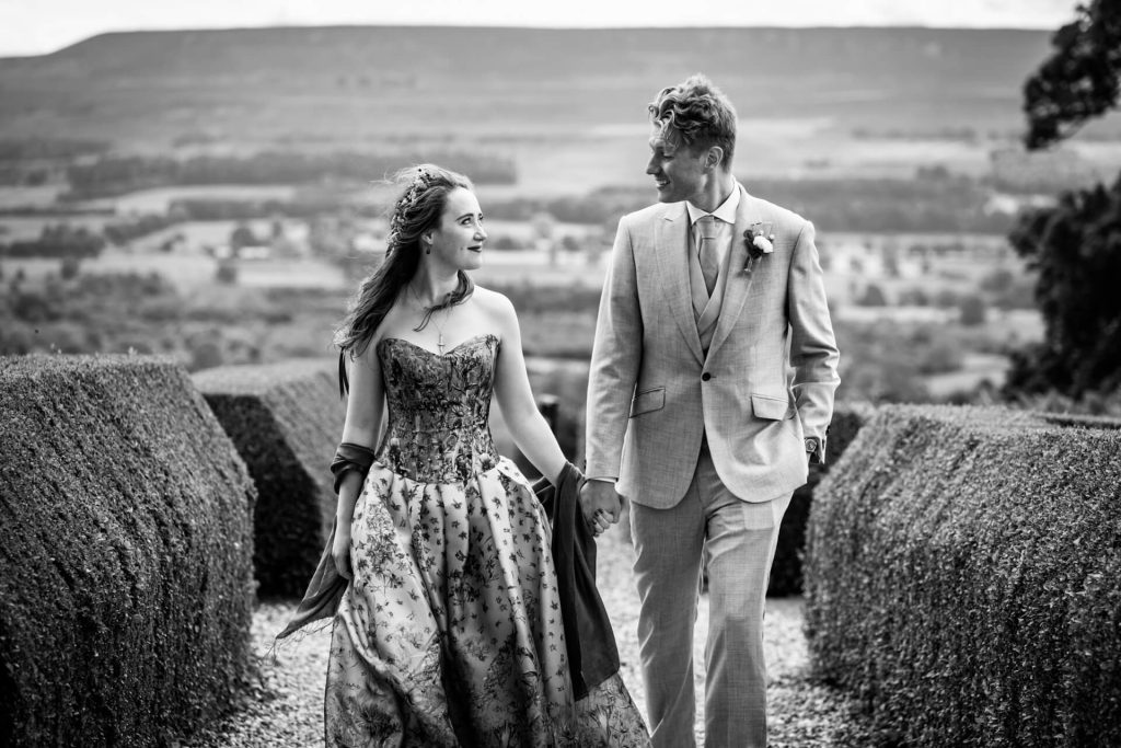 bride and groom walking in the maze at Bolton Castle