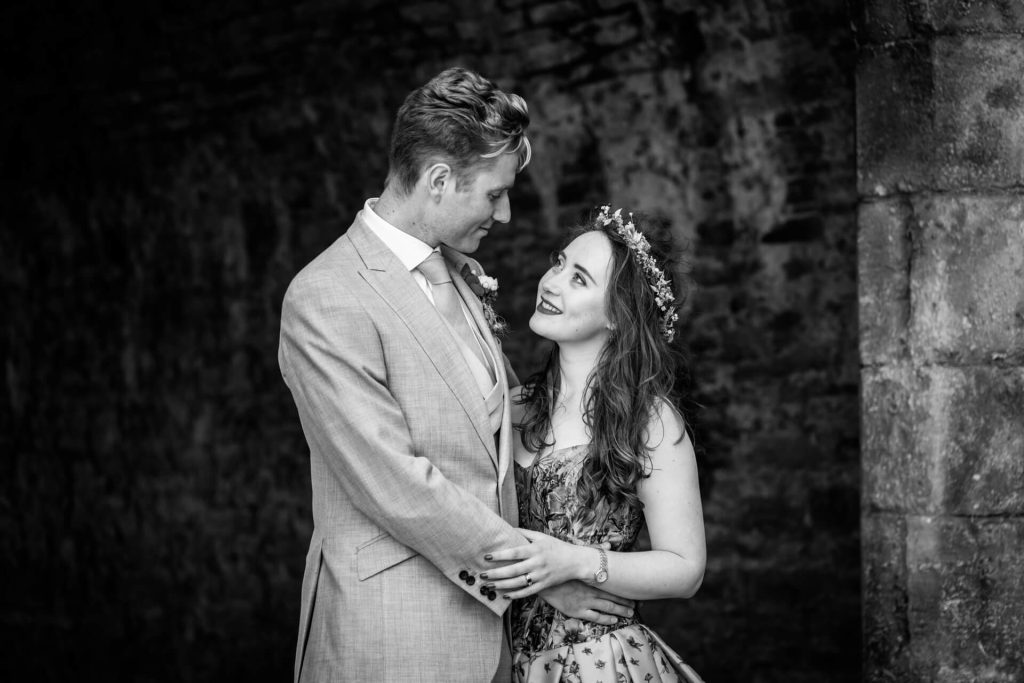 wedding couple looking at each other in the grounds of Bolton Castle