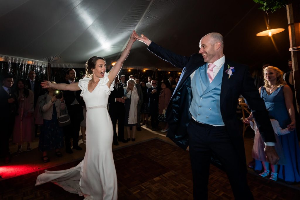 wedding couple dancing their first dance in front of their guests