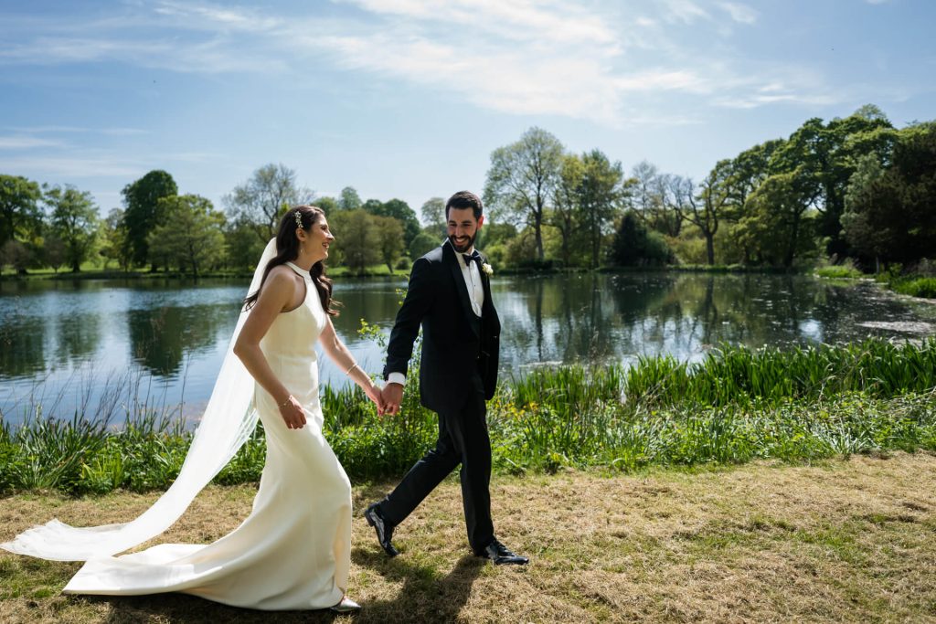 wedding couple walking by a lake