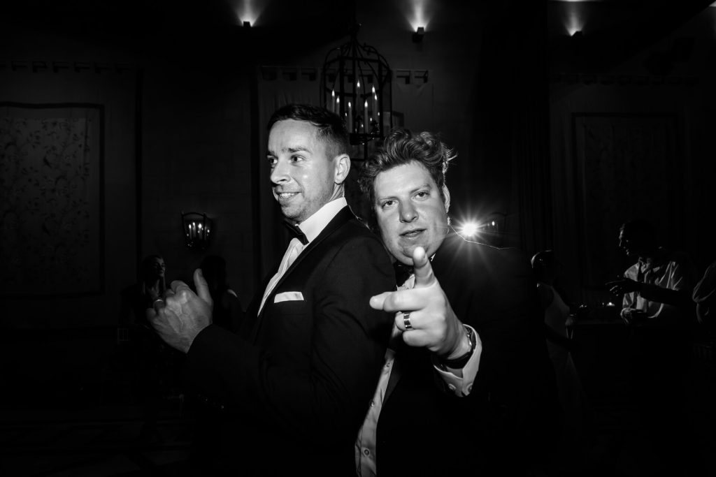 wedding guests dancing and pointing at the camera