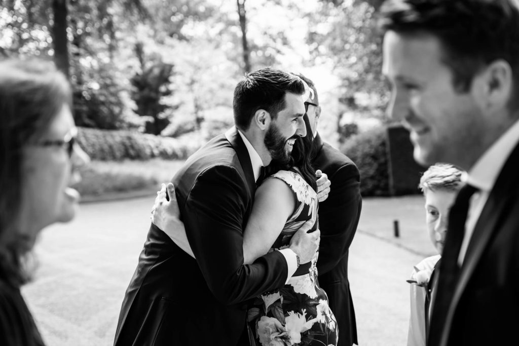 groom hugging one of the wedding guests