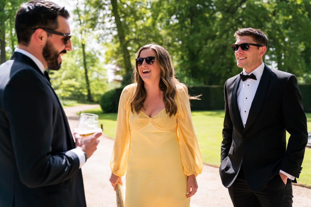 wedding guests talking to the groom
