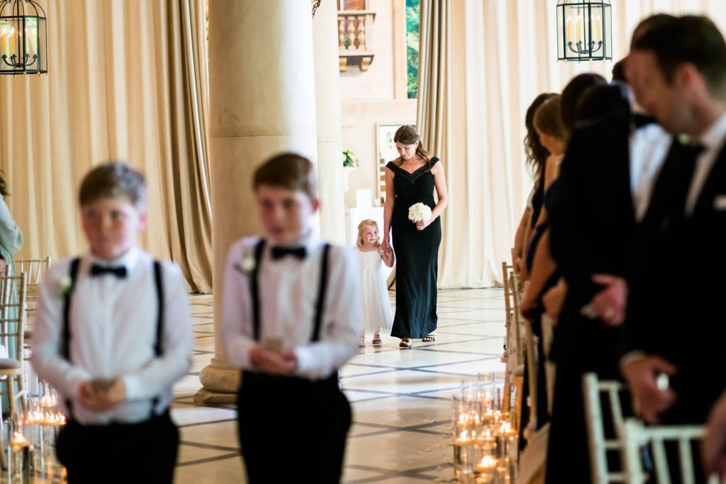 page boys and bridesmaids enter the ceremony room