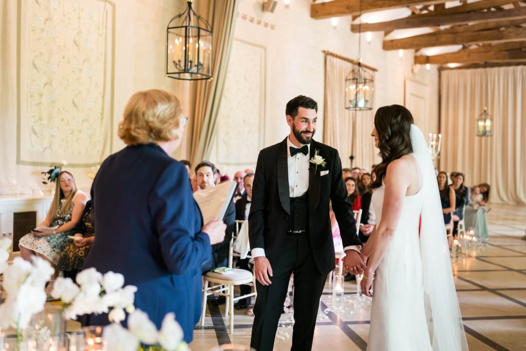 bride and groom holding hands during the ceremony