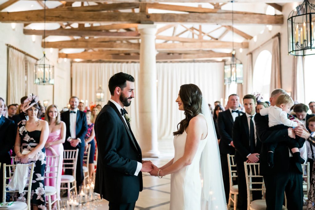 wedding couple holding hands during the ceremony