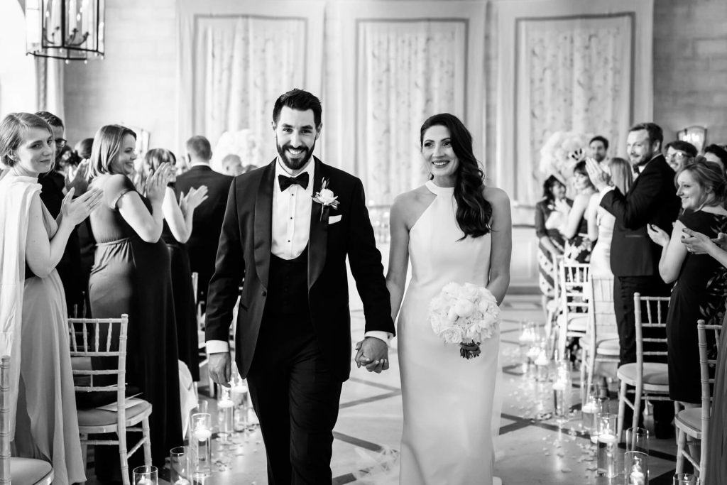 bride and groom walking down the aisle at the orangery at Settrington