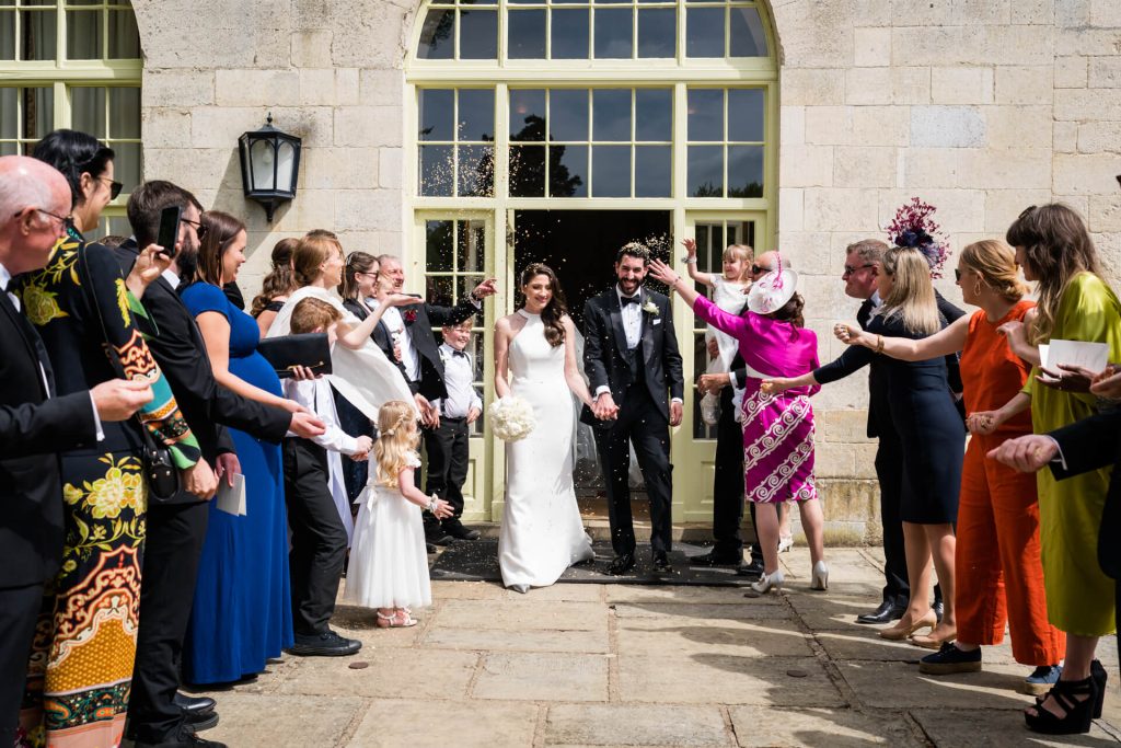 guests throwing confetti over the wedding couple