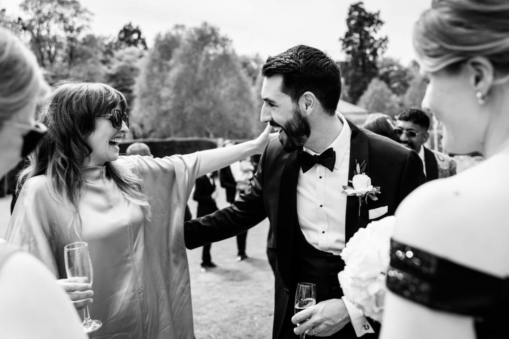 groom hugging a wedding guest