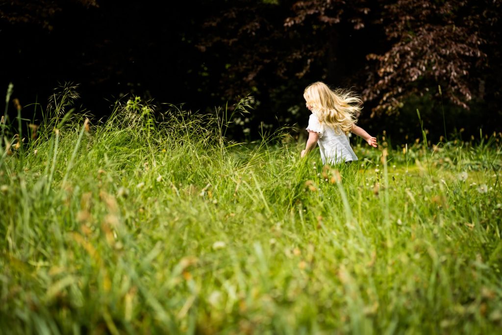 little girl running in the garden