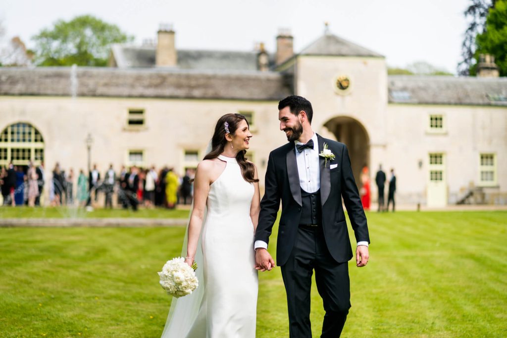 wedding couple walking together in the gardens at the orangery at Settrington