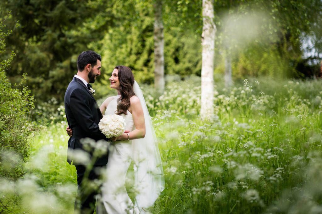 bride and groom hugging in the gardens at the orangery at Settrington