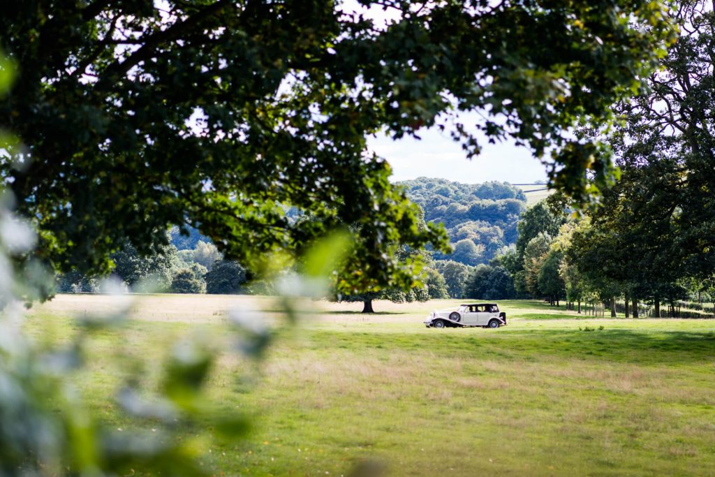 wedding car arriving at The Tithe Barn
