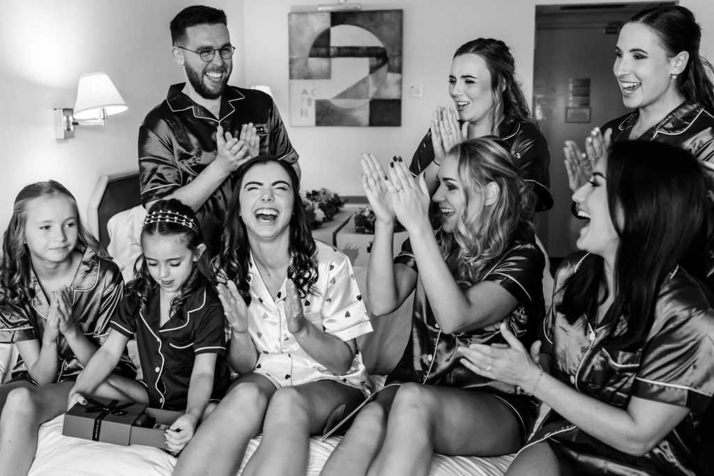 bride and her bride tribe all laughing together and clapping