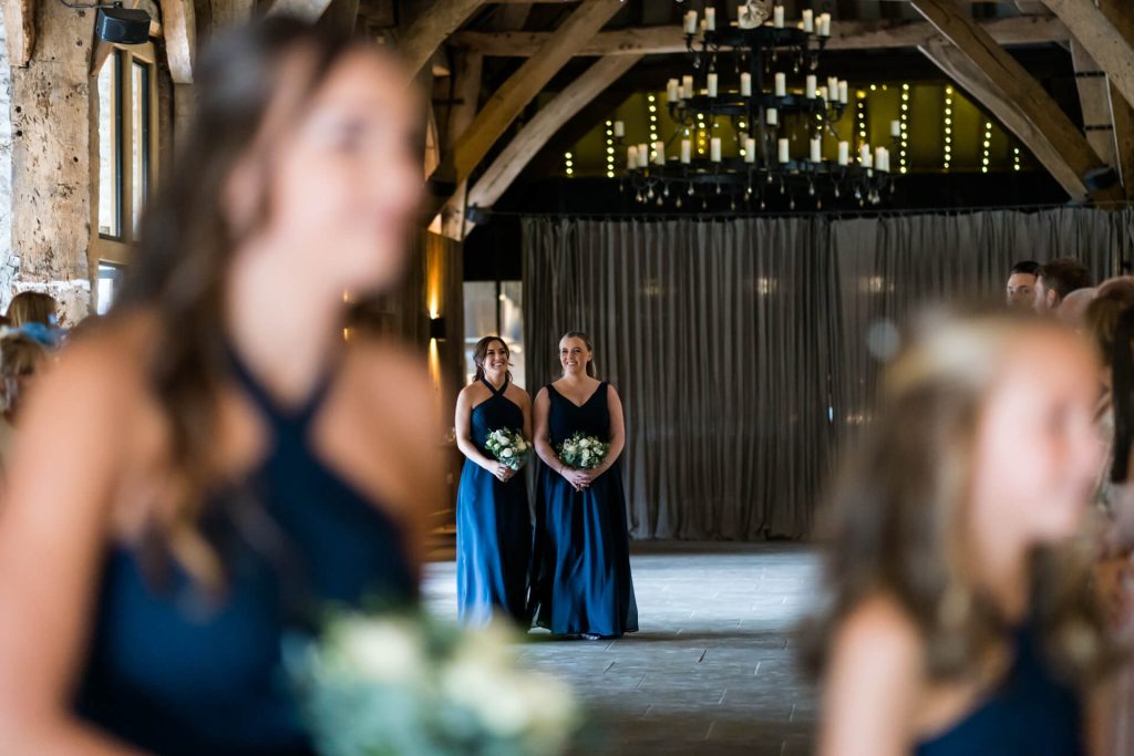 bridesmaids walk dow the aisle